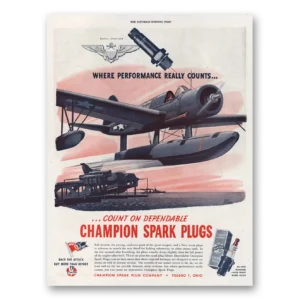 1944 Champion Spark Plugs Print Ad | Navy Scout Plane